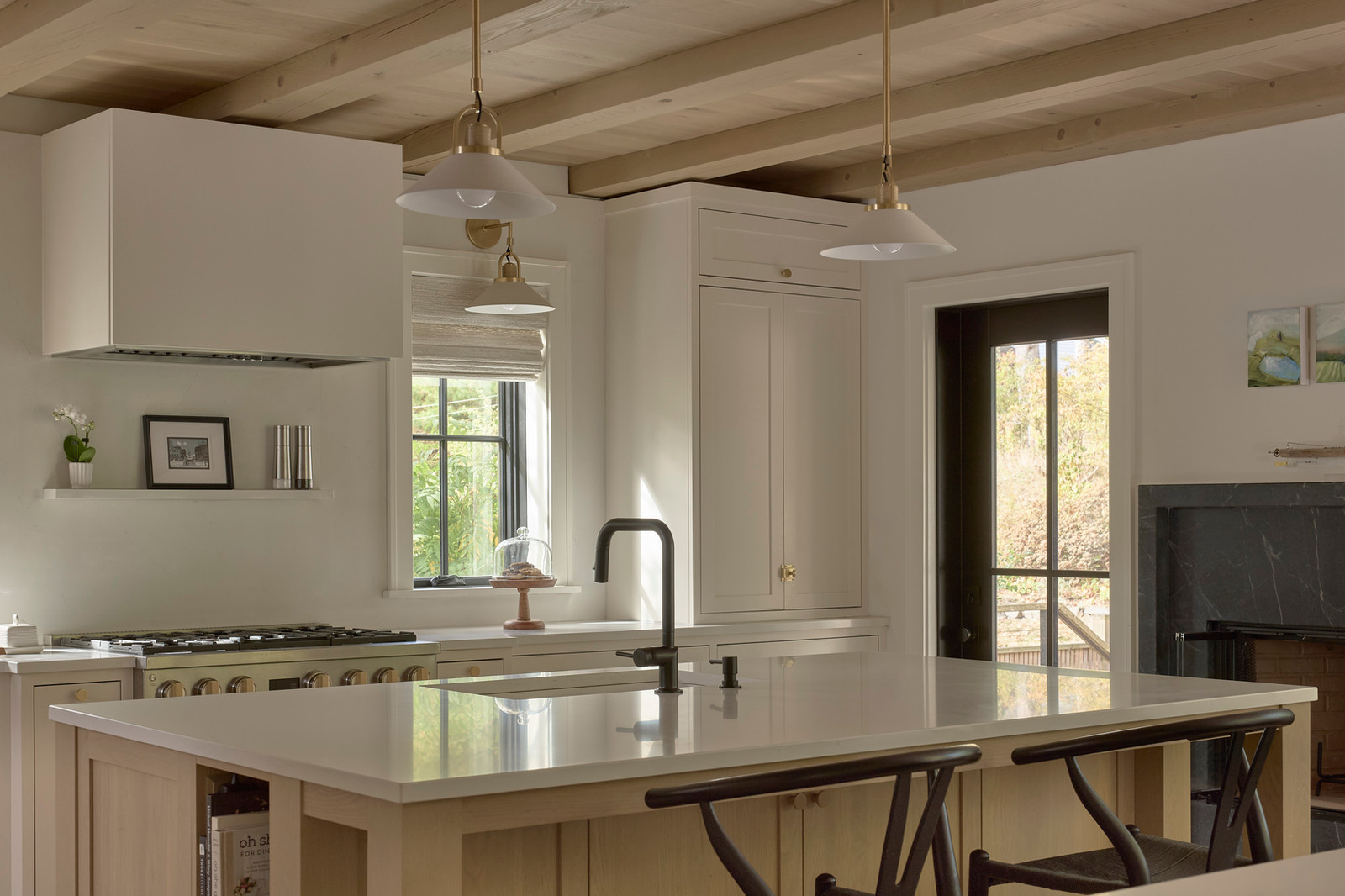 Inset custom cabinetry with white oak island and corner window — House on Kent