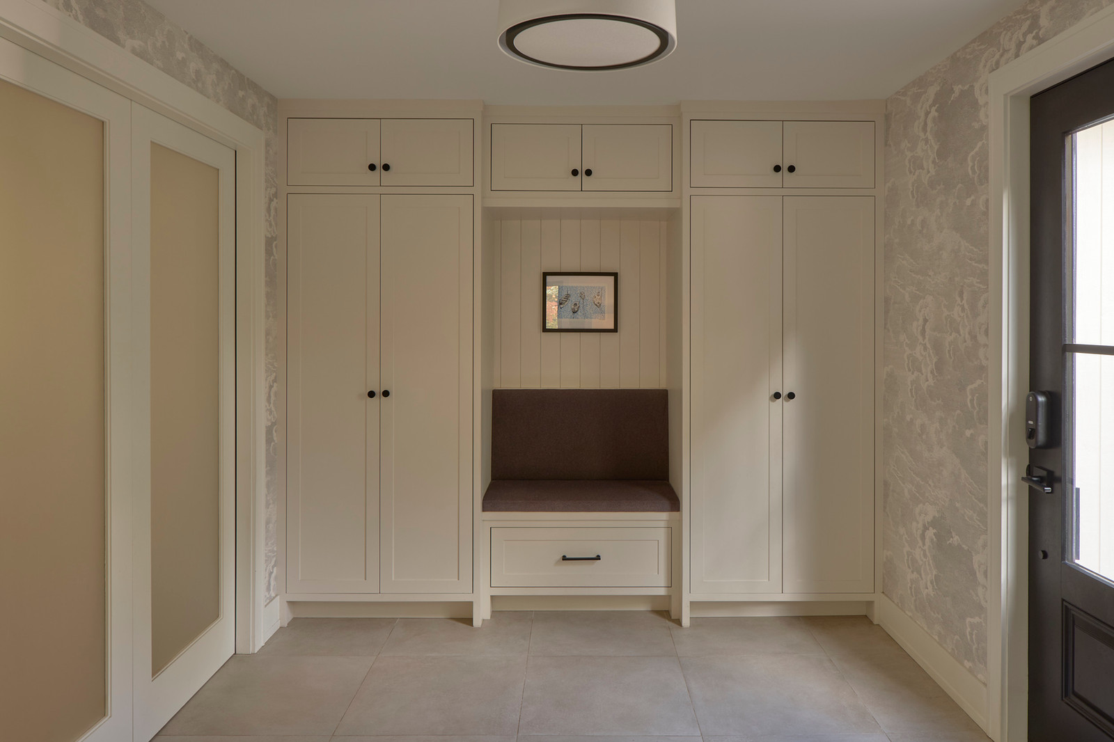 Custom entry cabinetry with painted millwork, upholstered bench and integrated storage — House on Kent