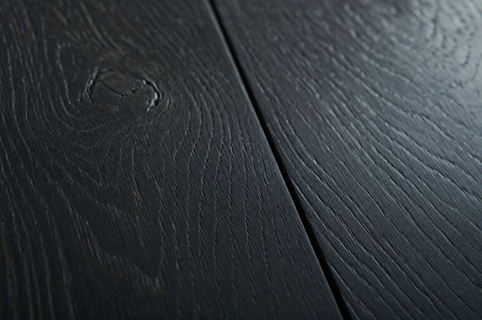 Wide-plank jet-black stained white oak cabinetry material sample