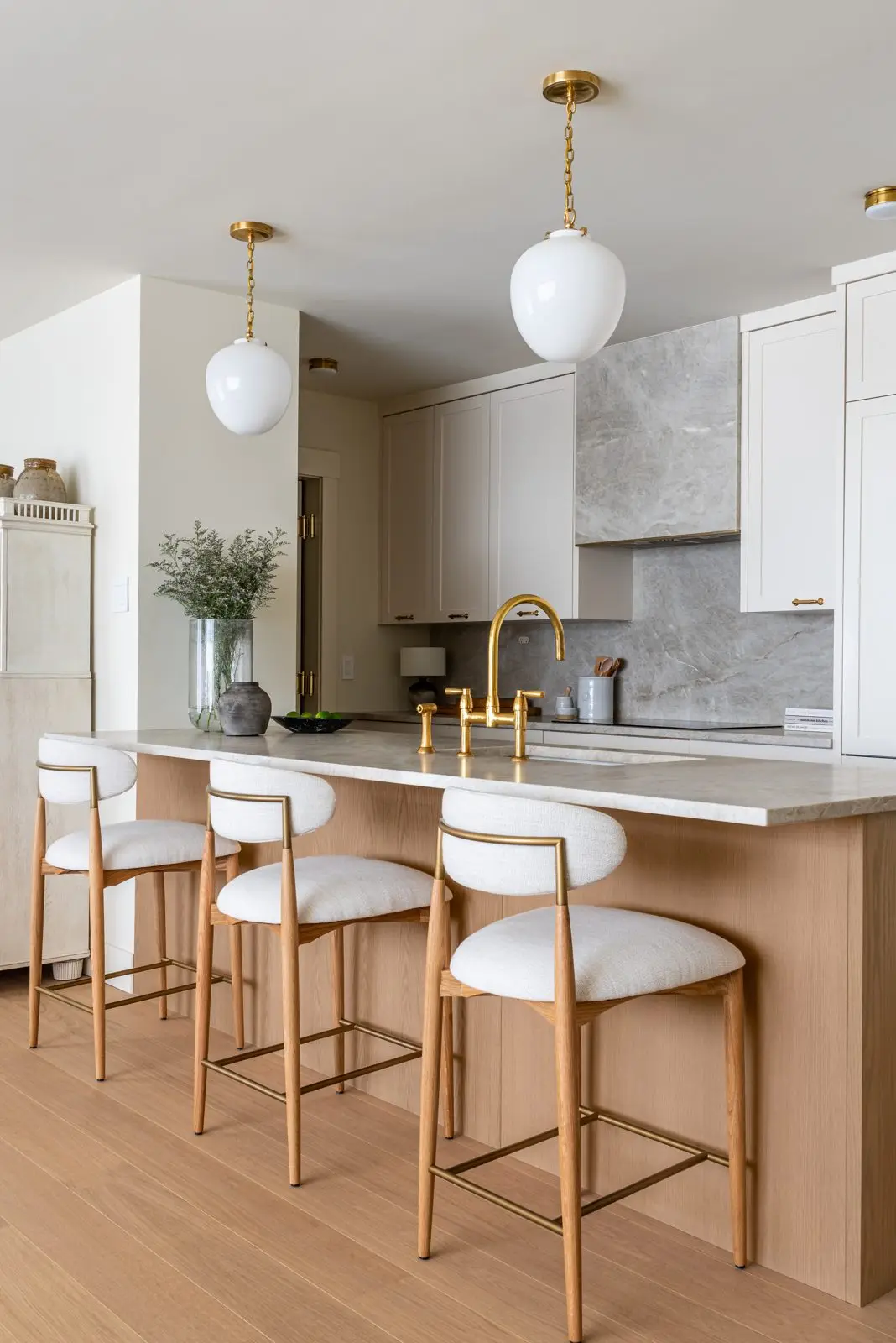 Painted panel kitchen cabinetry with brass hardware, rush-friendly
