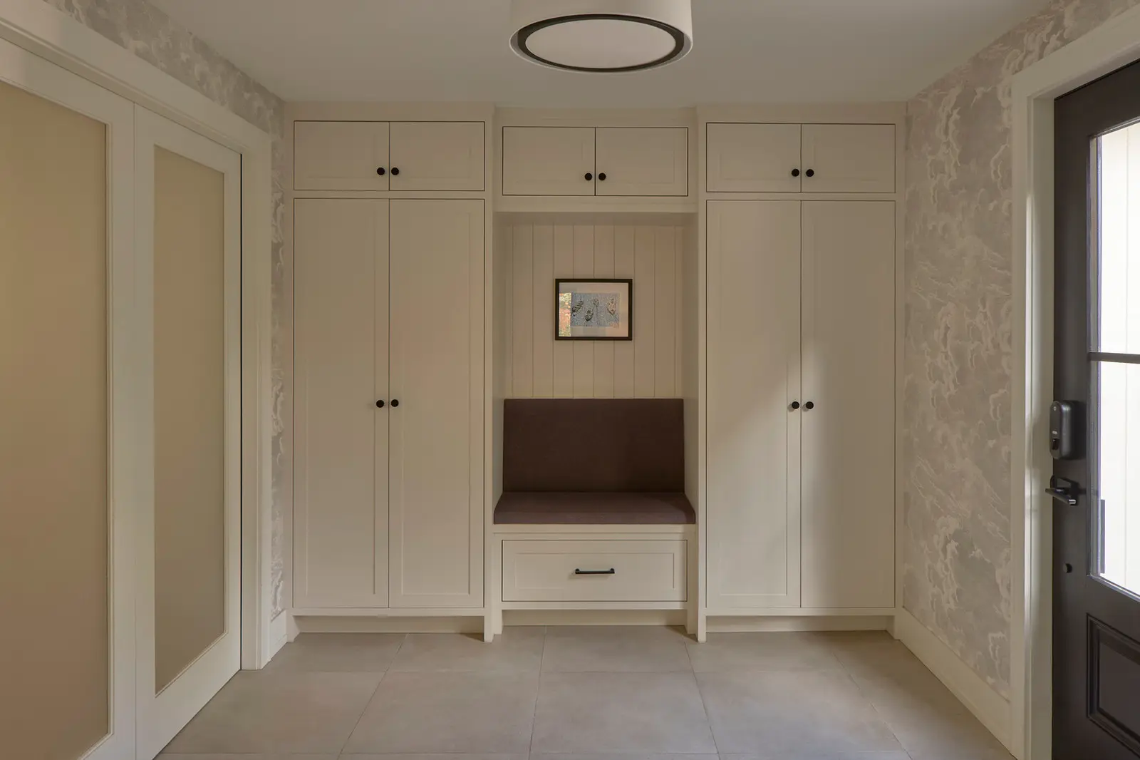 Custom entry cabinetry with painted millwork, upholstered bench and integrated storage — House on Kent