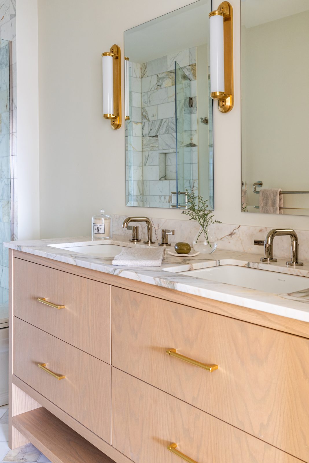 Light oak double vanity cabinetry with custom drawer bank