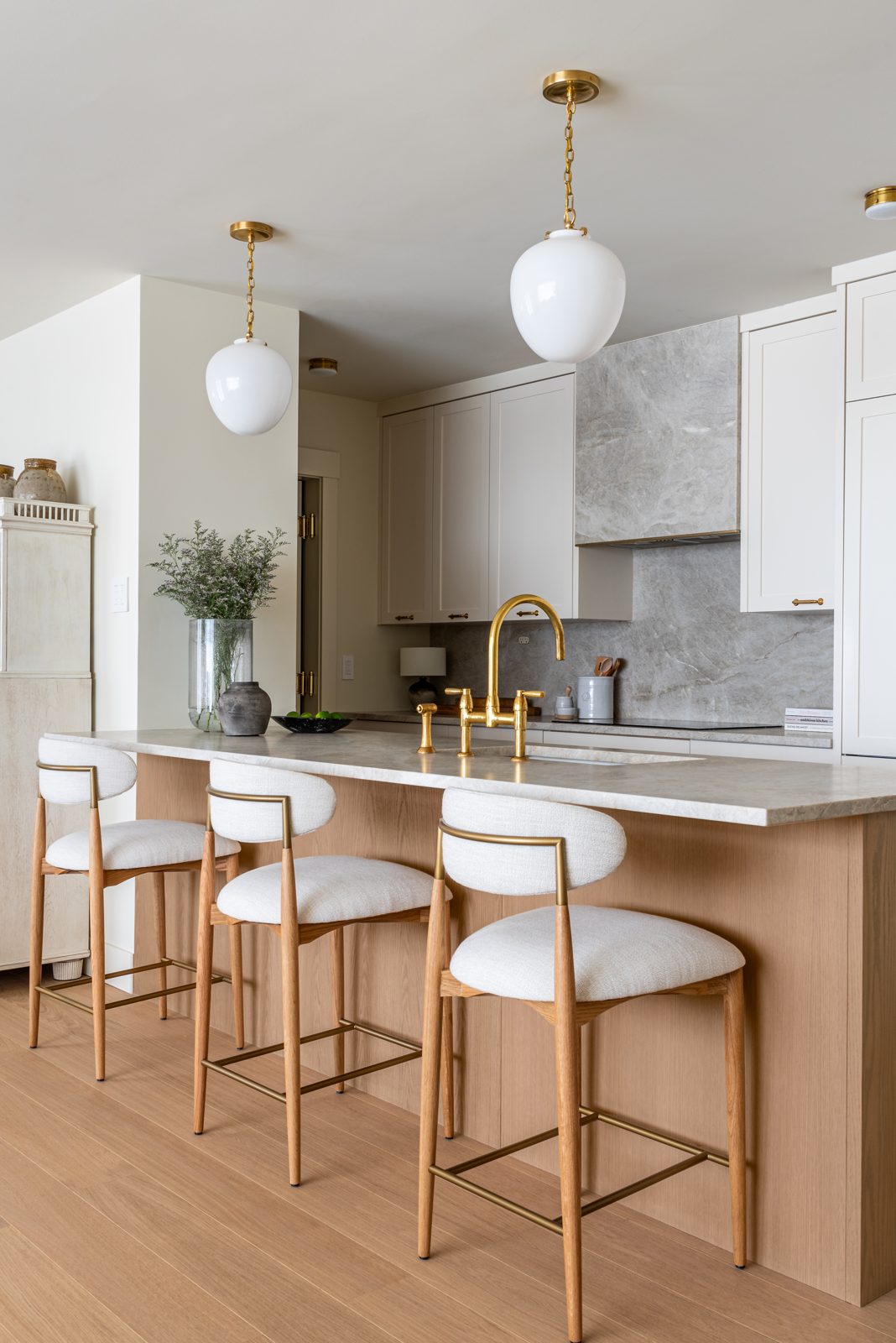 Custom white kitchen cabinetry with panelled island